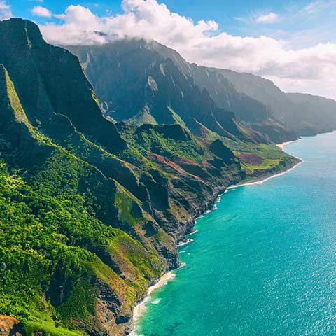 An aerial landscape view of beautiful Kauai showing the dramatic Na Pali coast on a Hawaii vacation