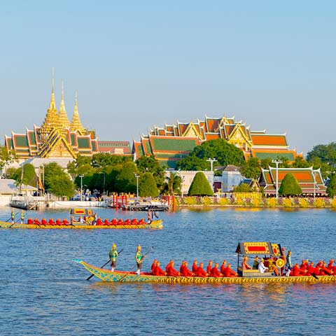 Bangkok's Grand Palace and Temple of Emerald Buddha (Wat Phra Kaew) with the royal barge procession for The Thai King on Chao Phraya River on a Thailand tour